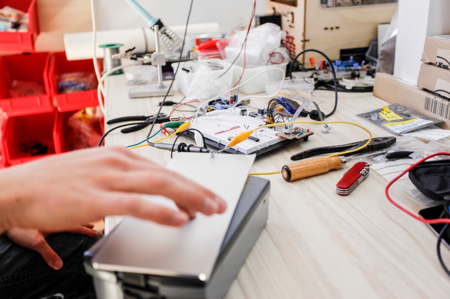 Desk with Haptic Explorer prototypes and electronic equipment.