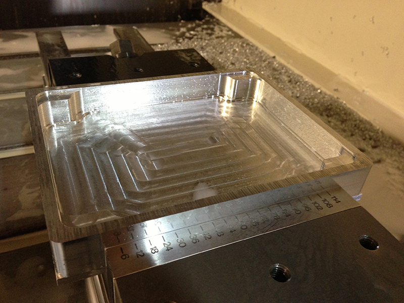 Enclosure on milling machine being milled from a solid block of aluminum.