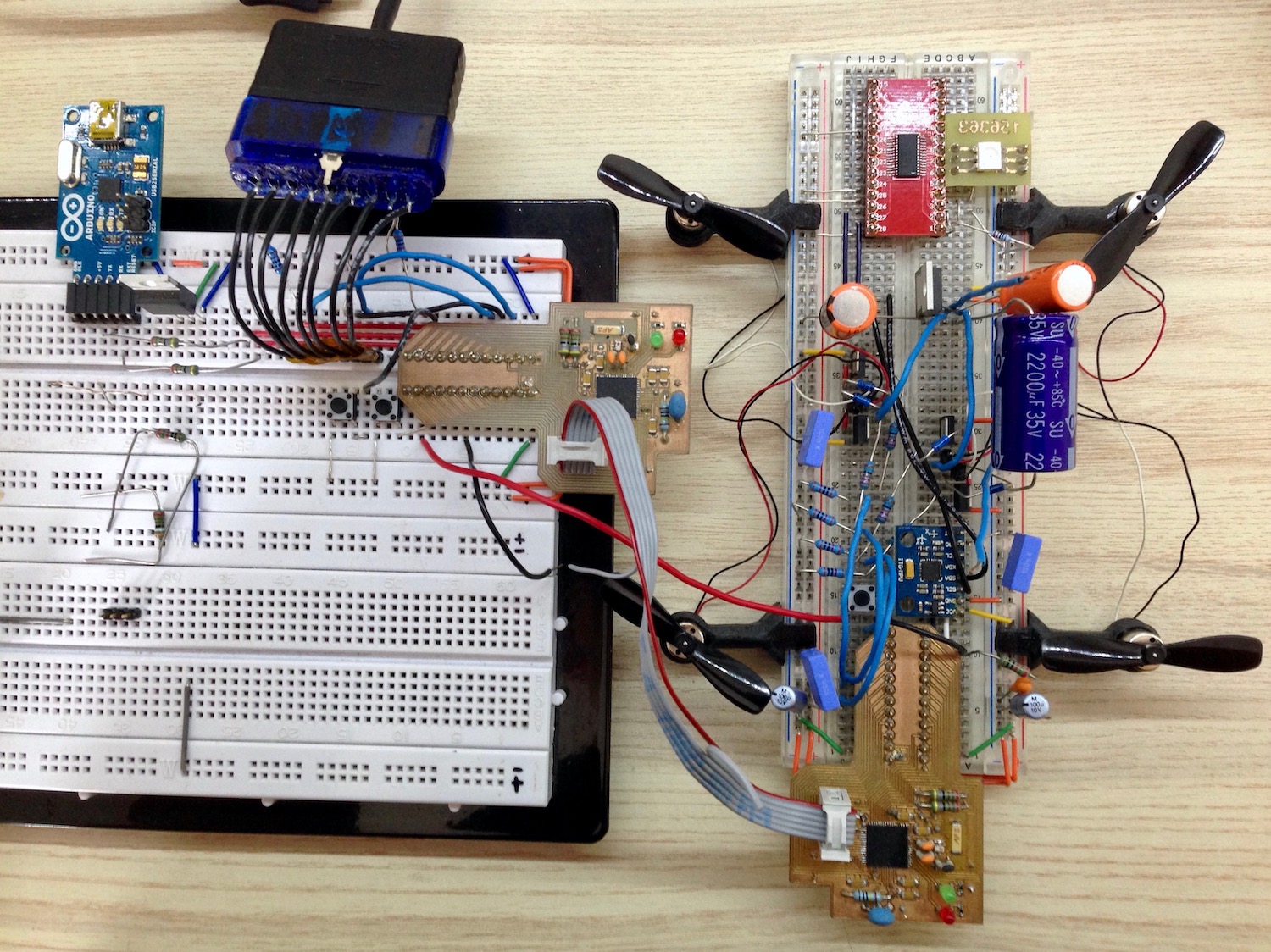 Development breadboard setup with custom prototyping PCBs and mounts for propellers.