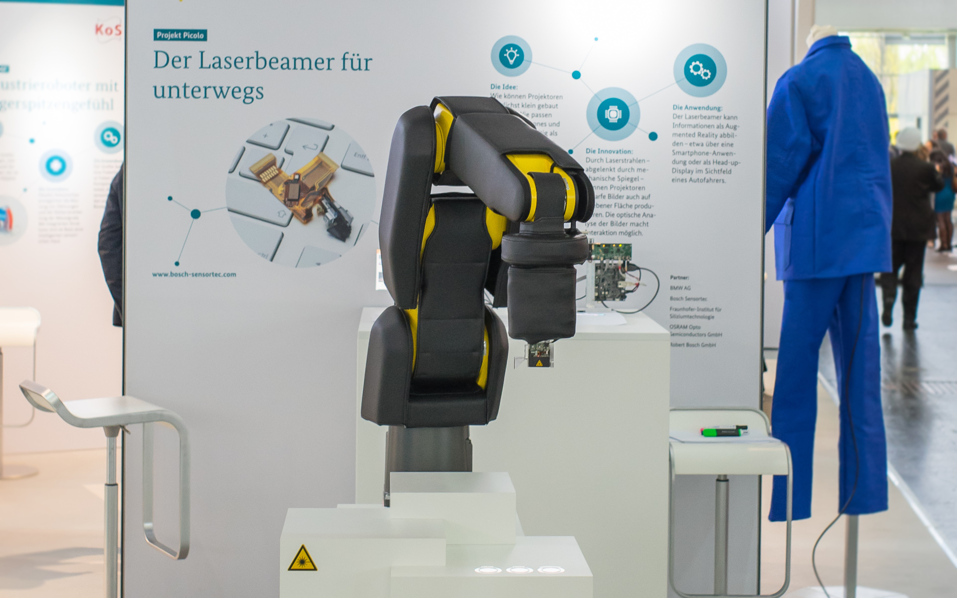 Robot using interactive laser projector to demonstrate an interface at Hanover Fair 2016.